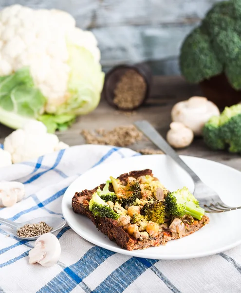 Vegan pizza pie with broccoli, mushrooms and chickpeas dough wit