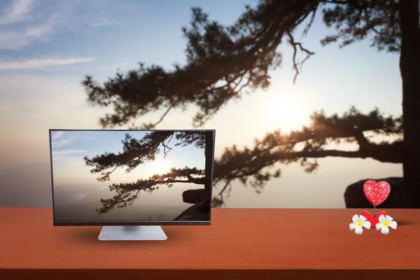 The computer on table and background nature