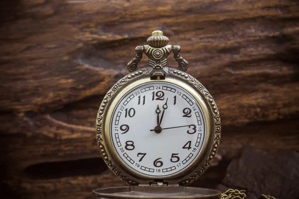 Retro pocket watch ancient on wood