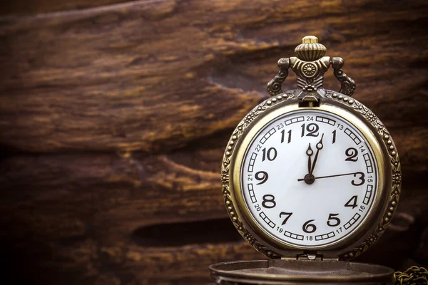 Retro pocket watch ancient on wood