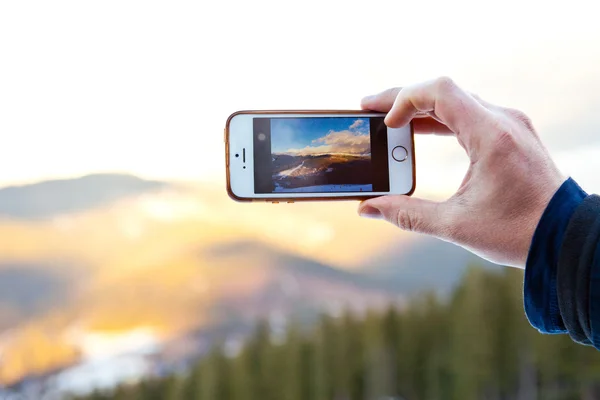 Camera mobile phone at beautiful sunrise