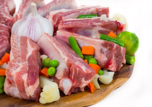 Uncooked ribs, meat and vegetables
