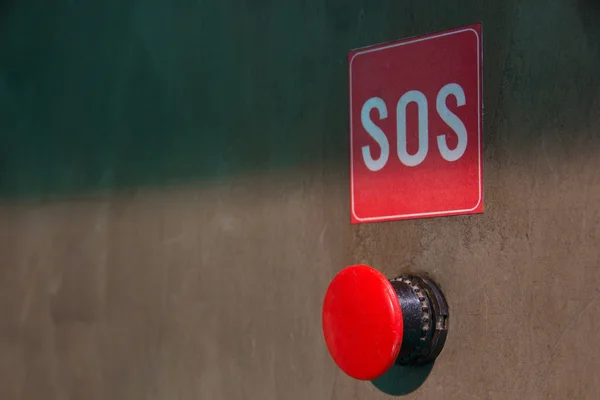 The red SOS button on a gray background