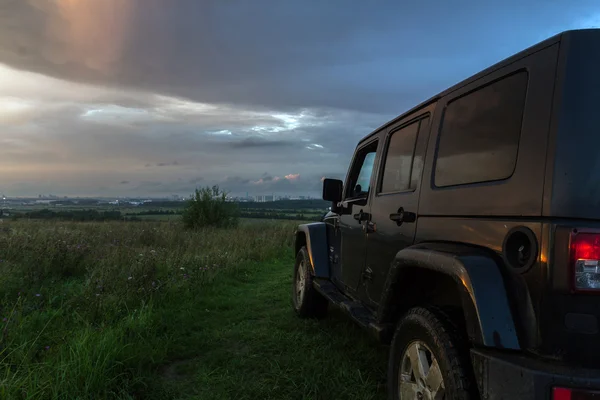 Leningrad region, Russia , July 30, 2016 , Jeep Wrangler at sunset on grief Pulkovo, the Jeep Wrangler is a compact four wheel drive off road and sport utility vehicle