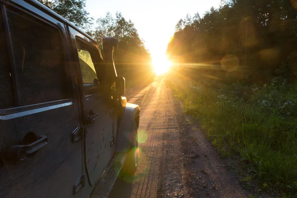Novgorod oblast, Russia , 03 August, 2015 , Jeep Wrangler on a rural road in the Novgorod region, the Jeep Wrangler is a compact four wheel drive off road and sport utility vehicle