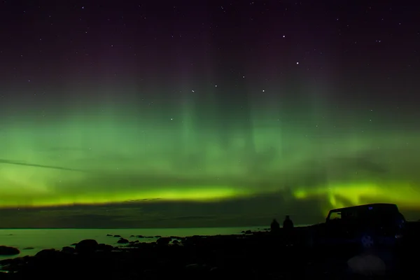 Northern lights on lake Ladoga, Russia, November 03, 2015 , travel by Jeep Wrangler