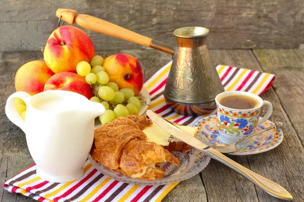 Breakfast with croissants, coffee and fruit