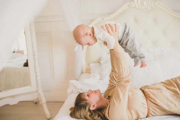 Happy cheerful family. Mother and baby kissing, laughing and hug