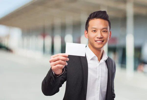 Asian man holding white card