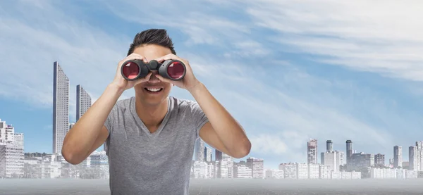 Handsome young asian man with binoculars