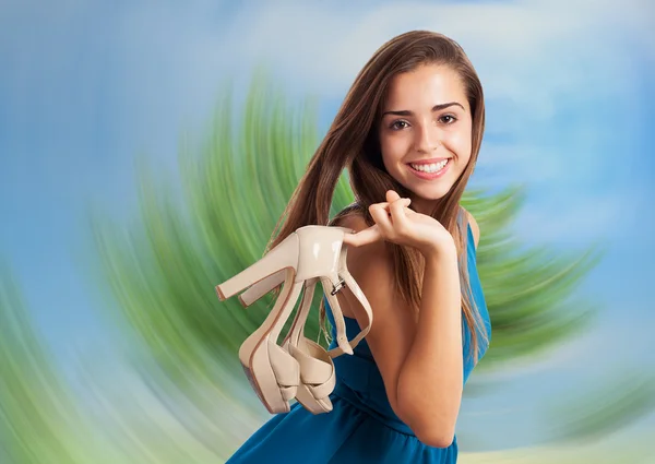 Young cute woman holding shoes