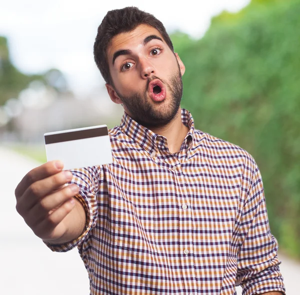 Young man holding credit card