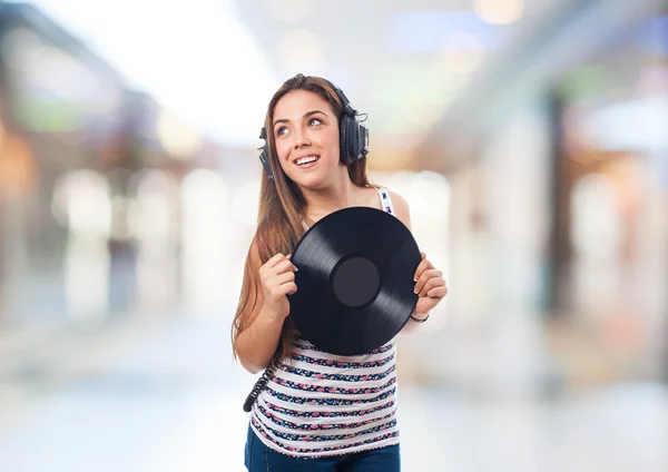Girl holding a vinyl listening to music