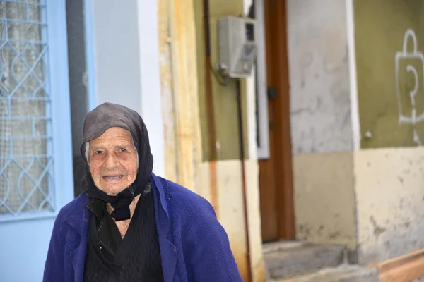 Greek woman iwalking in her typical Greek village Aggiasos.