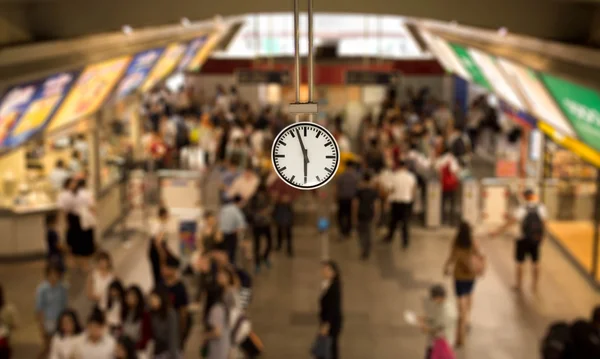 Selected focus Clock watch in train station at with people movin
