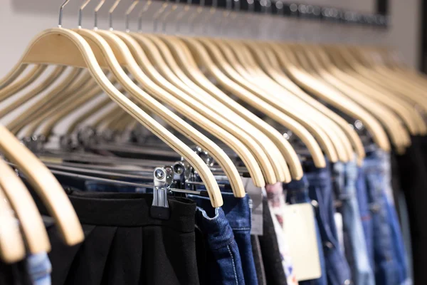 Clothes hang on a shelf in a designer clothes store