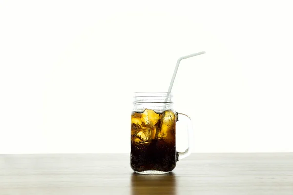 Glass of fizzy drink Cola with ice isolated