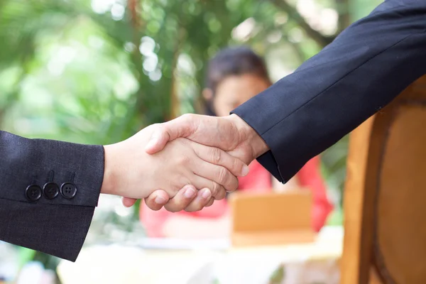 Business handshake and blur lighe background