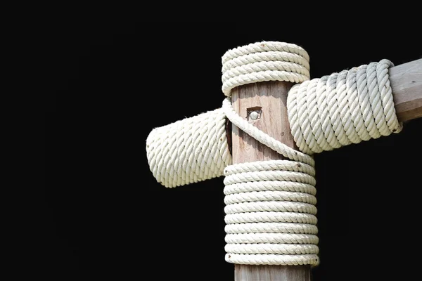 Layers of rope tied around a wooden log