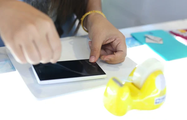Woman applying a screen protector on an cellphone