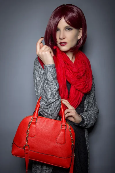 Woman holding red purse