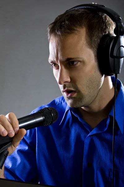 Male voice over artist on a microphone