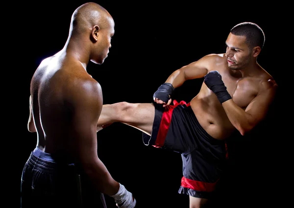 MMA instructor teaching student