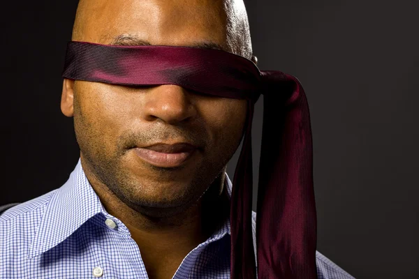 Black businessman blindfolded