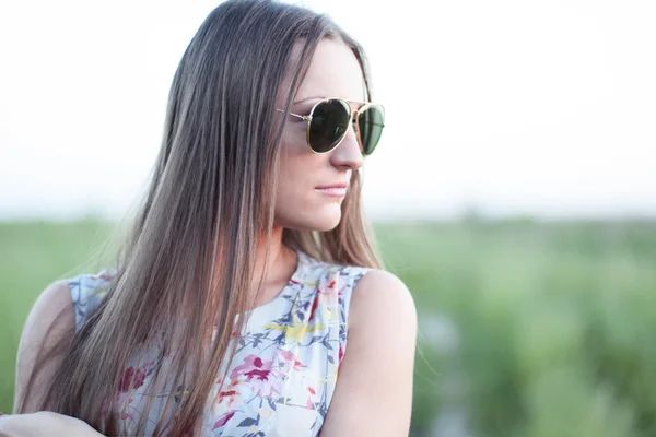 Beautiful girl field green meadow in summer park delicate dress, enjoying leisure, fashion style, glamor life,  student at a bright sunny day.