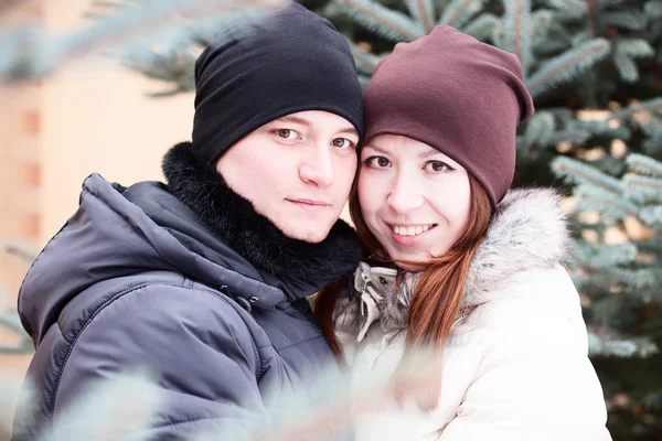 Young couple in winter park, woods, resting enjoying walk, happy family, idea  style  concept love relationships, clothes hats