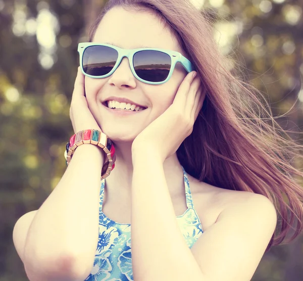 Beautiful natural beauty  little girl schoolgirl student wears glasses dress summer bright sunny day outdoors fresh air idea concept fashion style happy smiles