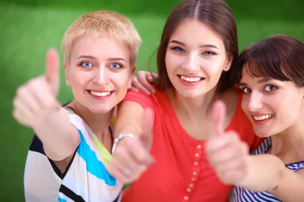 Three happy girls pointing fingers at you choosing