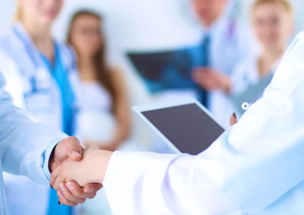 Young medical people handshaking at office