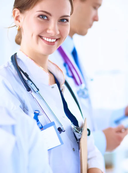 Attractive female doctor in front of medical group