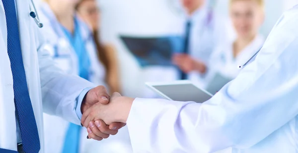 Young medical people handshaking at office