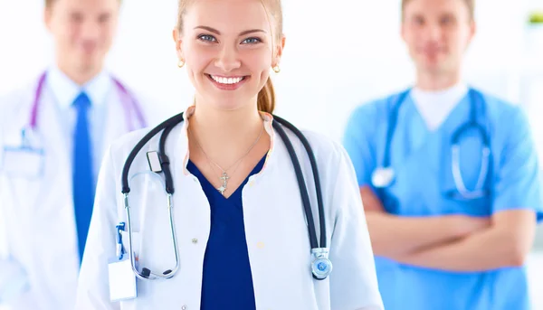 Attractive female doctor in front of medical group