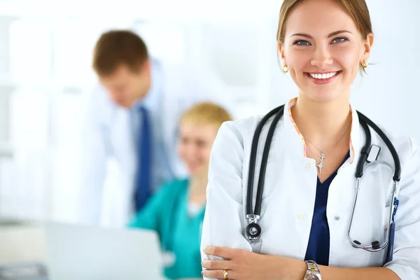 Attractive female doctor in front of medical group