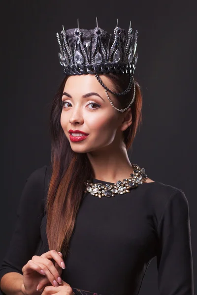 Beautiful woman with diamond crown and jewerly, isolated on black background