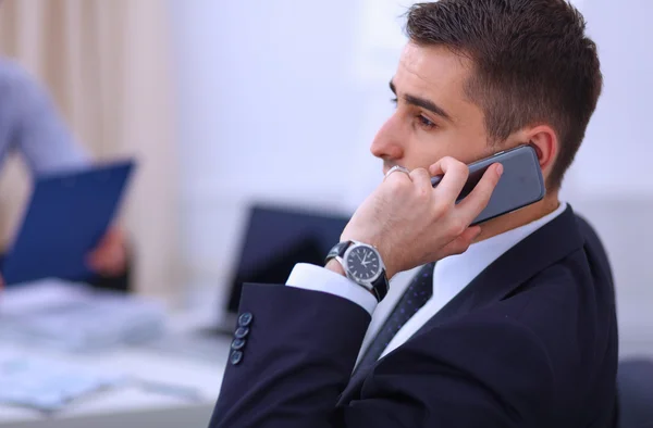 Business people talking on phone at office