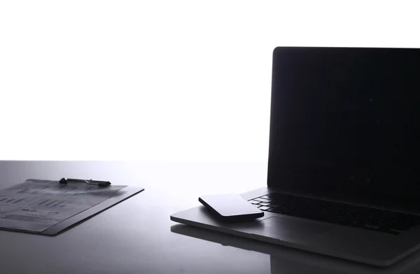 Modern home office with computer and laptop, folder, phone lying on the desk