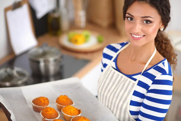 Woman is making cakes in the kitchen