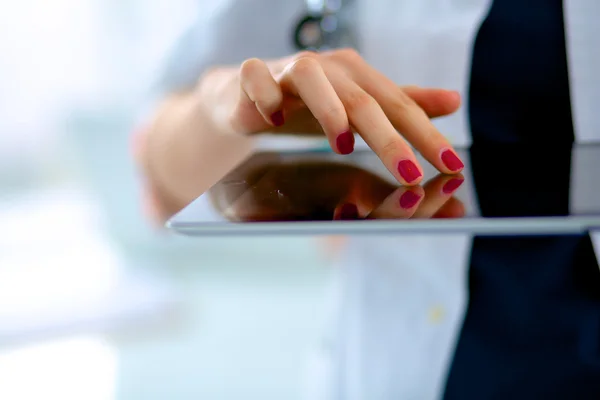 Young woman doctor holding a tablet pc