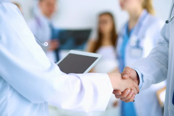 Young medical people handshaking at office