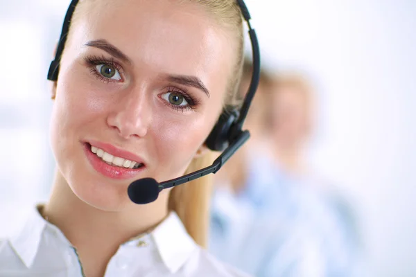 Attractive positive young businesspeople and colleagues in a call center office