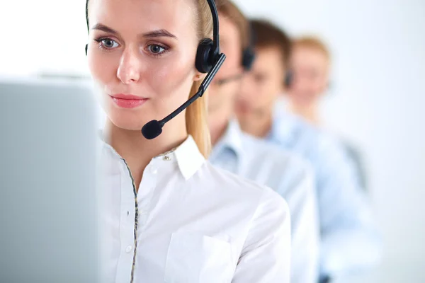 Attractive positive young businesspeople and colleagues in a call center office