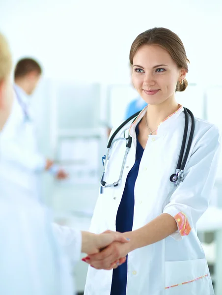 Young medical people handshaking at office