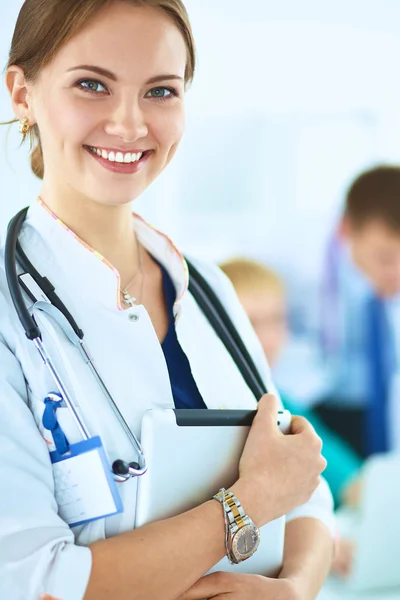 Attractive female doctor with folder in front of medical group