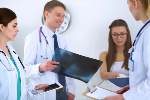 Surgeon and doctor analyzing x-ray together in medical office