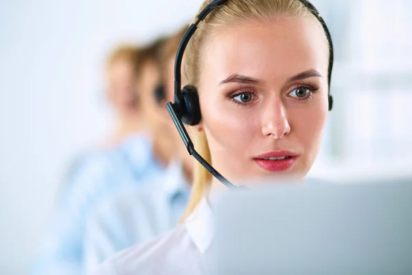 Shot of a call center operator sitting in front of her computer