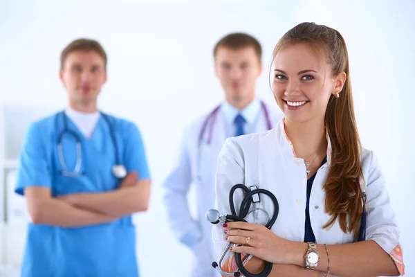 Attractive female doctor in front of medical group